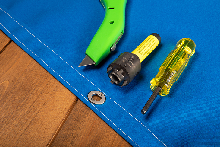 Install Twist-Lock fastener eyelets with an eyelet hole cutter or knife and the prong bending tool.